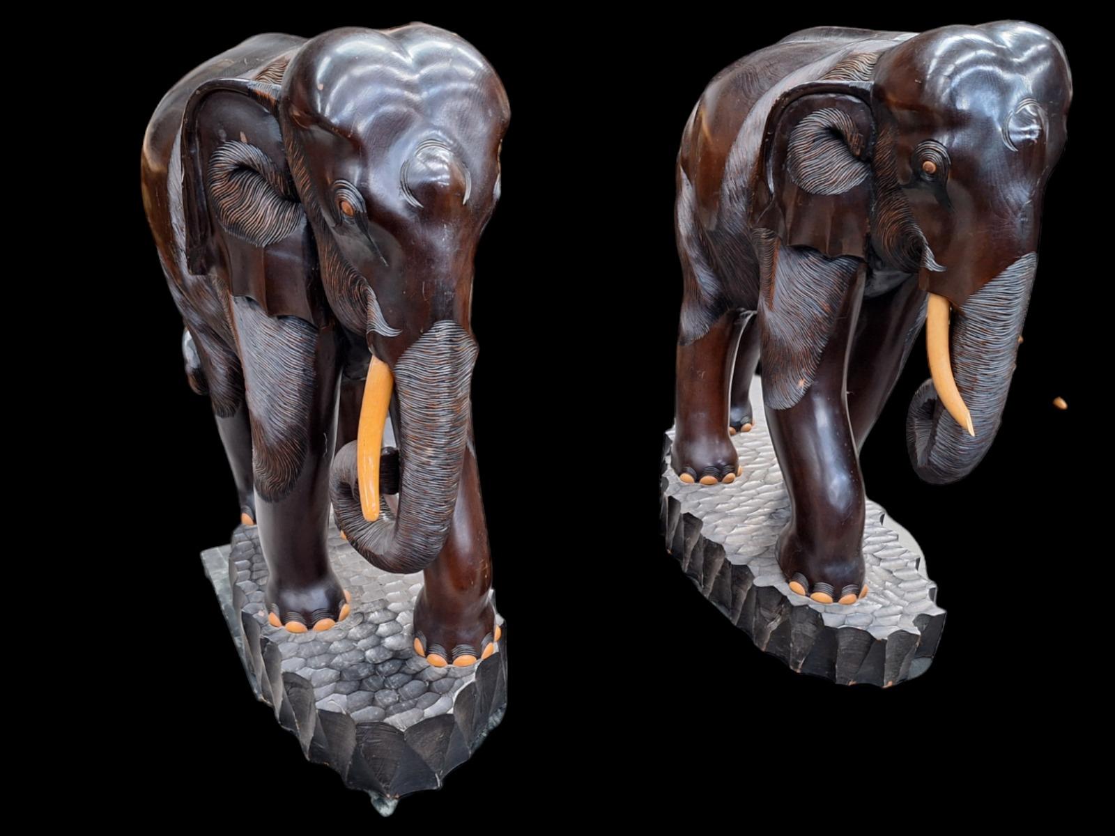 A pair of dark hardwood elephants.