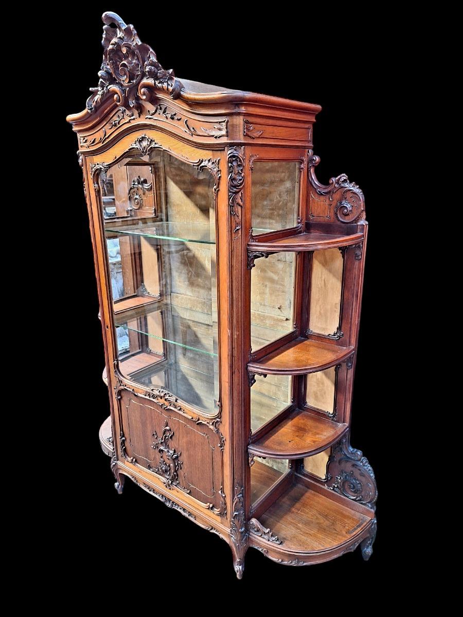 A rococo style Walnut display cabinet.