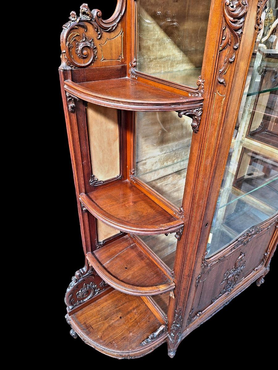 A rococo style Walnut display cabinet.