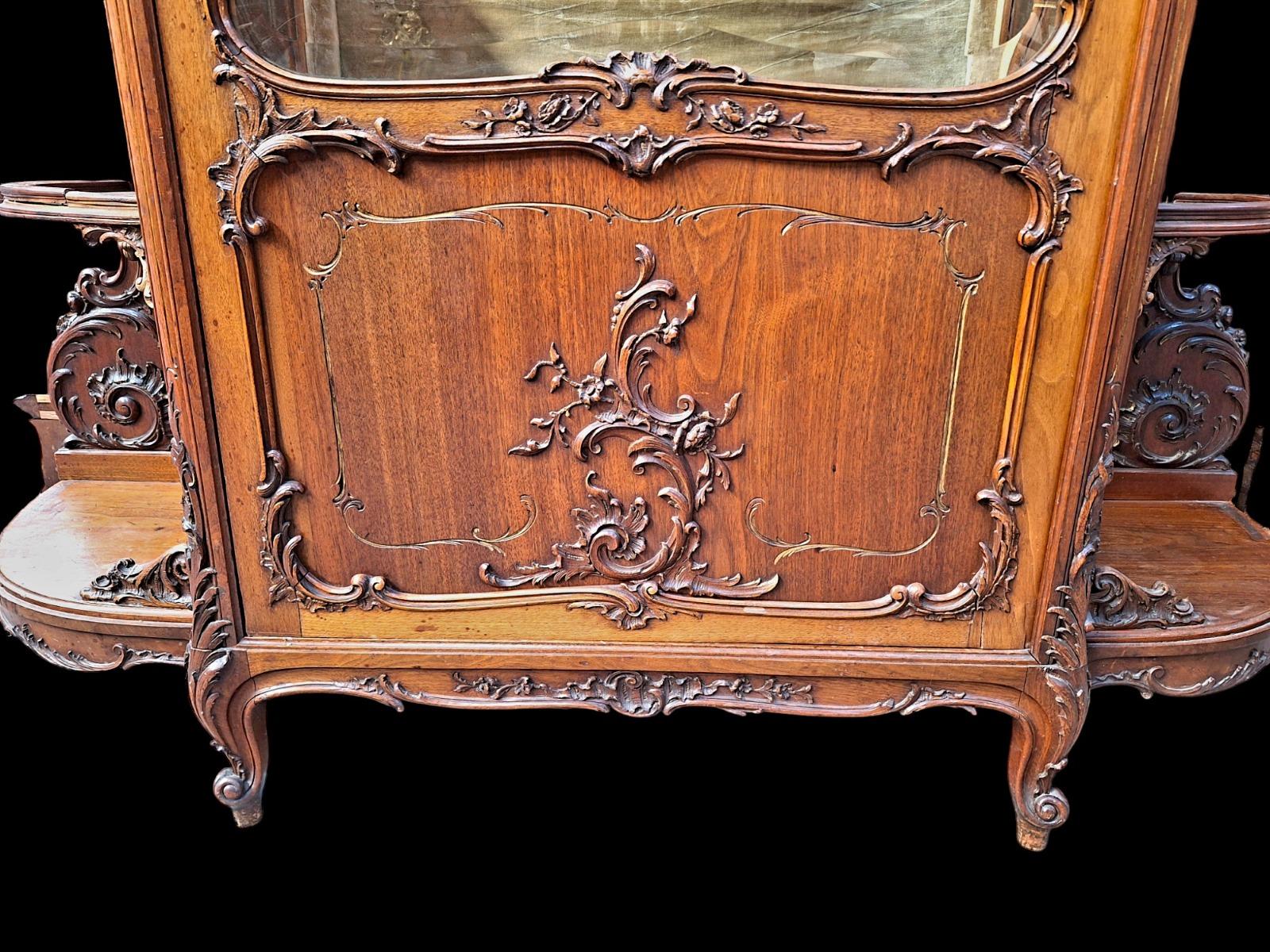 A rococo style Walnut display cabinet.