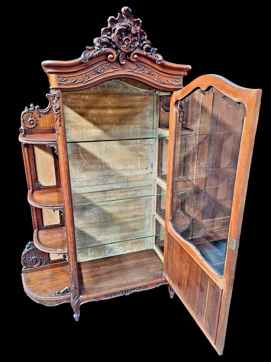 A rococo style Walnut display cabinet.