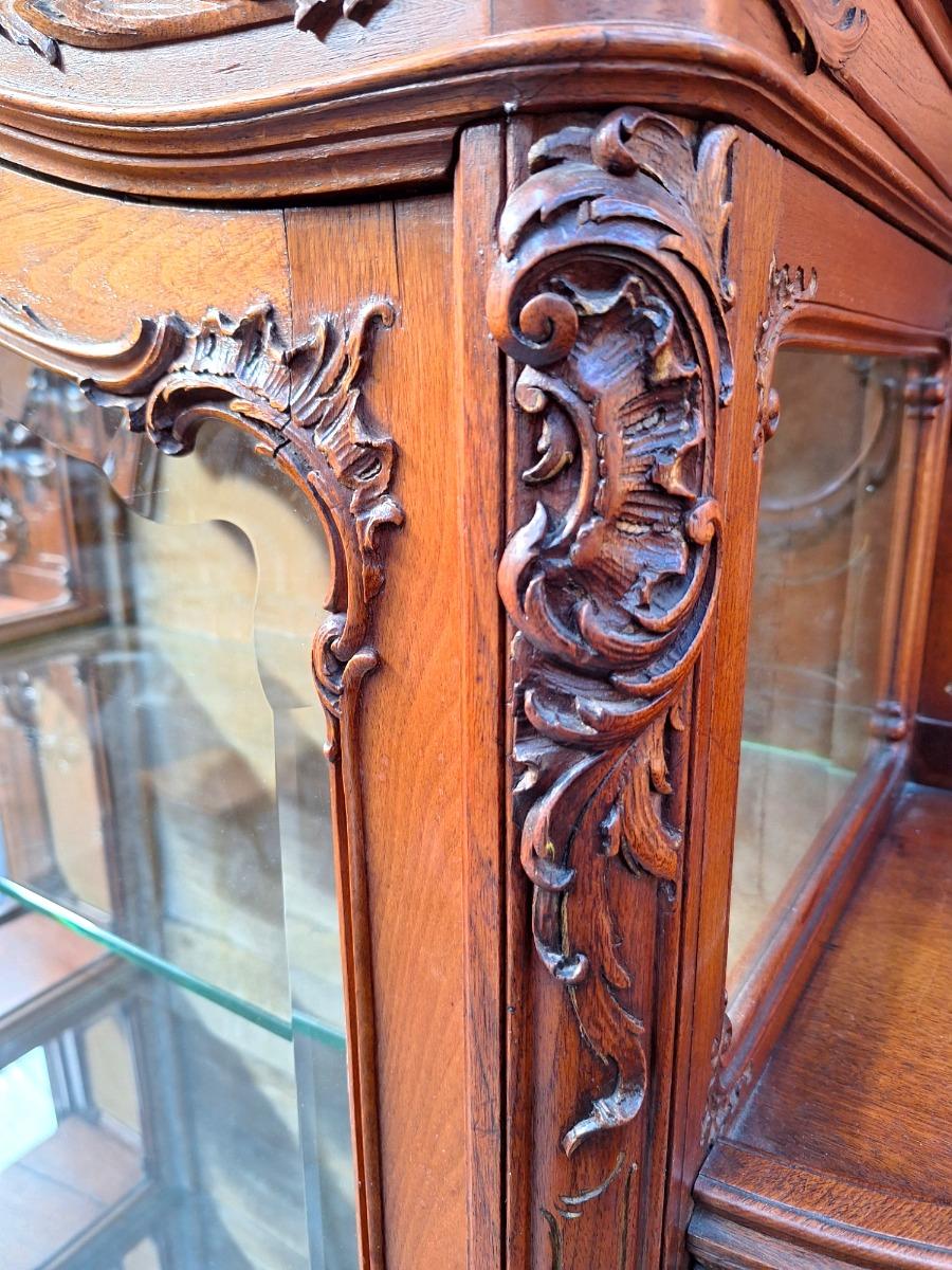 A rococo style Walnut display cabinet.