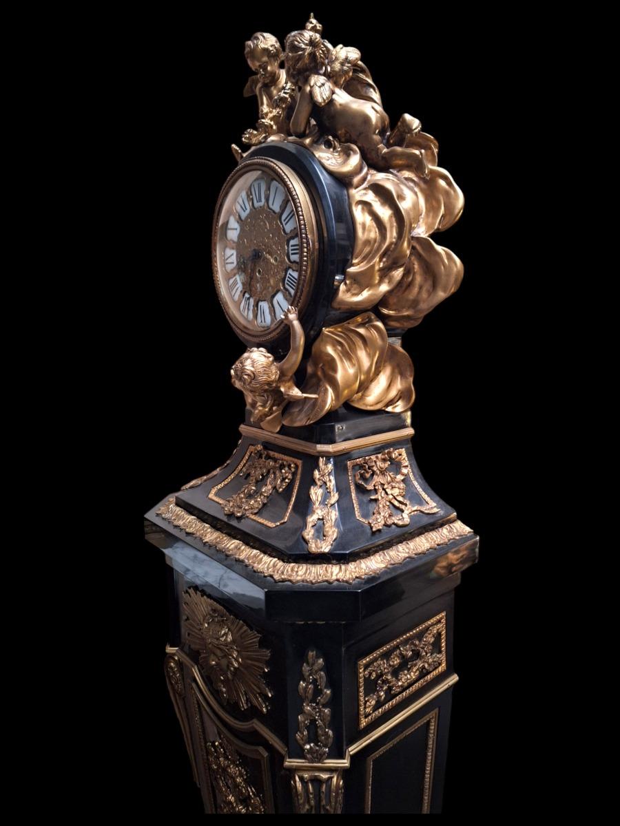 Clock in ebonized wood and ormolu mounts.