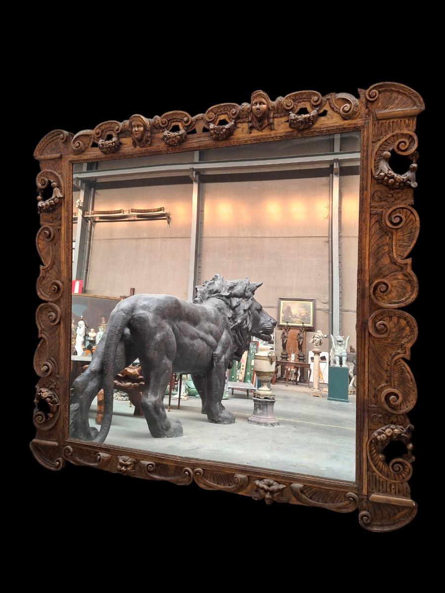 Monumental mirror in guilded wood.