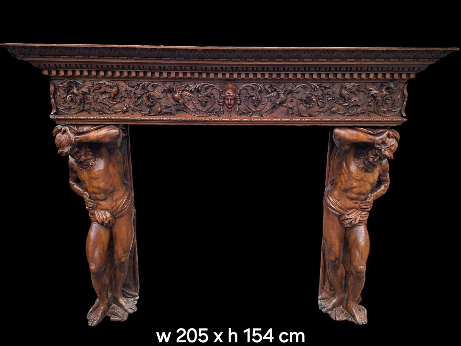 Monumental Renaissance style wallnut fireplace.