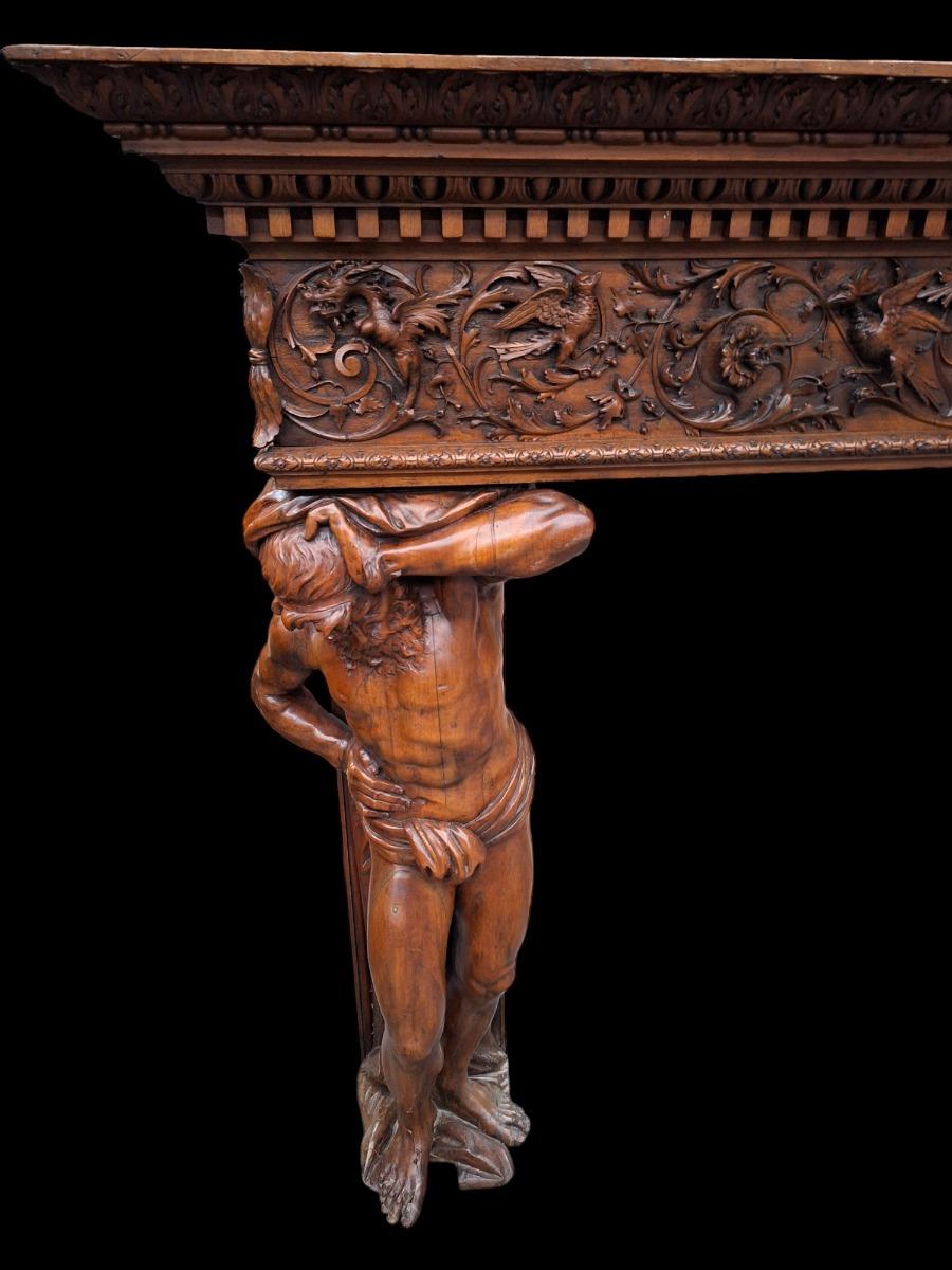 Monumental Renaissance style wallnut fireplace.