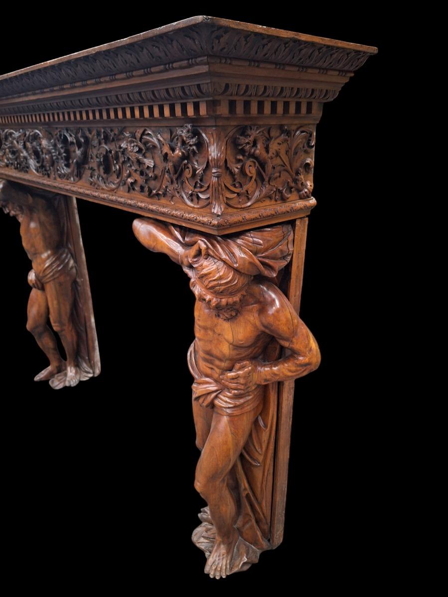 Monumental Renaissance style wallnut fireplace.