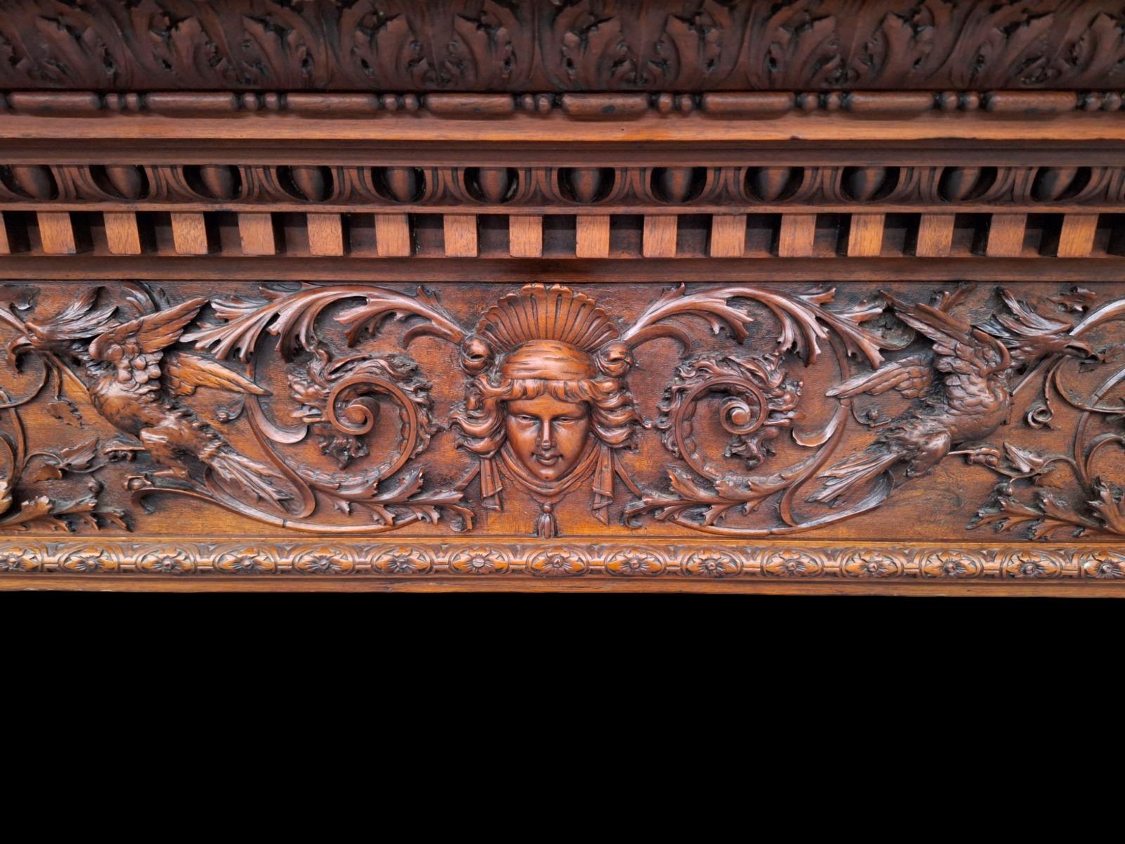 Monumental Renaissance style wallnut fireplace.