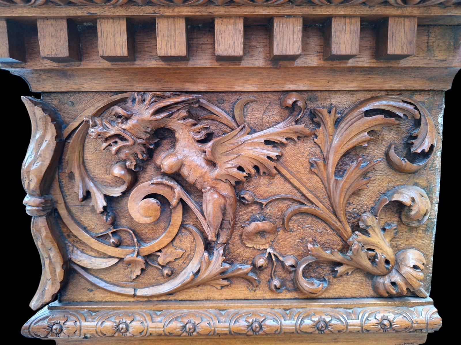 Monumental Renaissance style wallnut fireplace.