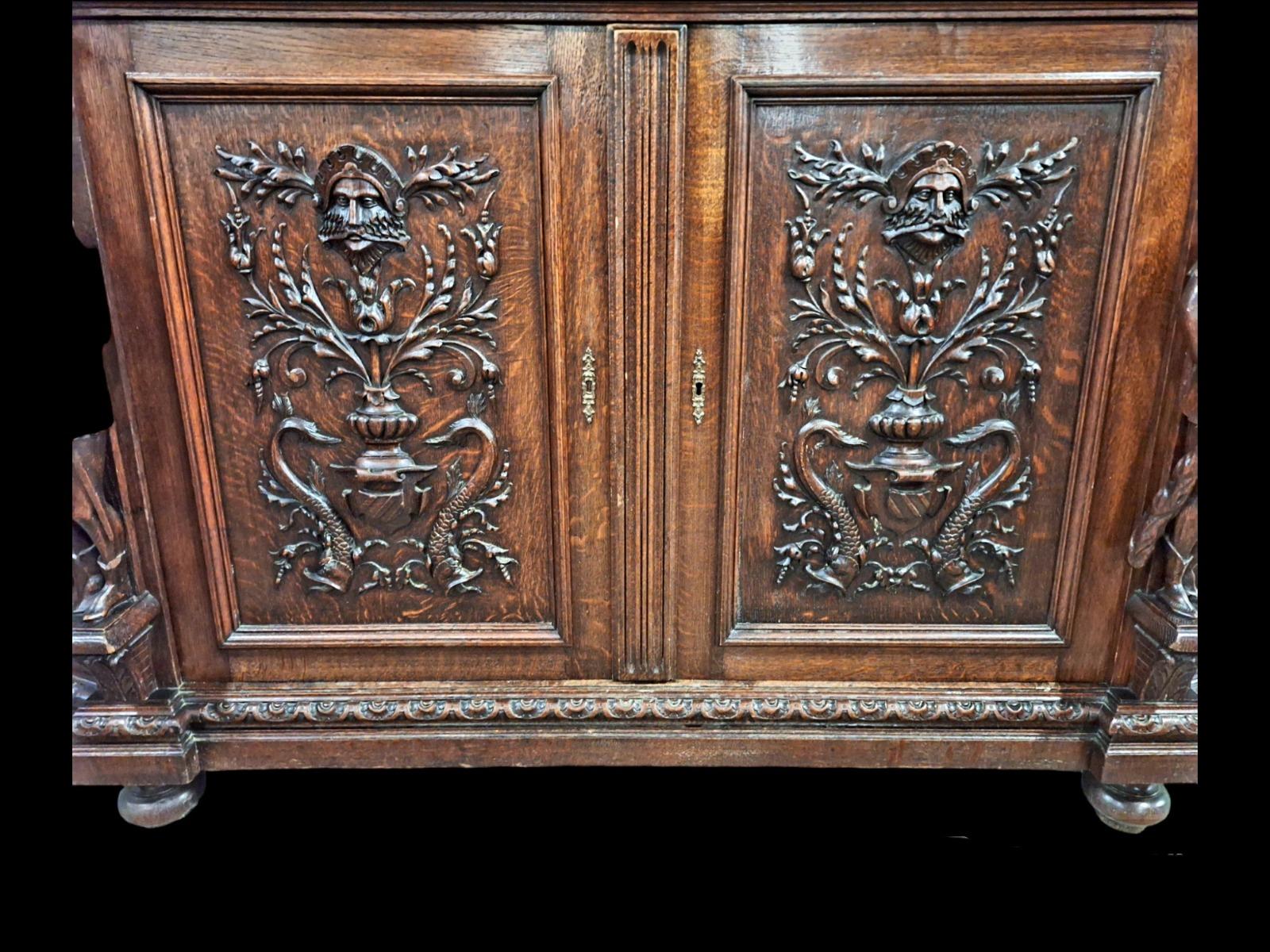 Richly carved Renaissance styled dining suite.